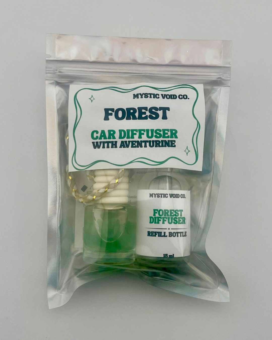 Car diffuser set with refill bottle and packaging labeled 'Forest' by Mystic Void Co on a gray background.